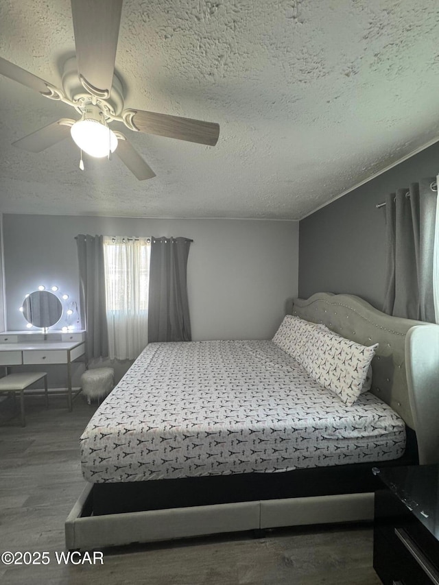 110 Heisel St, Kenton, OH 43326 - bedroom featuring a textured ceiling, wood finished floors, and a ceiling fan