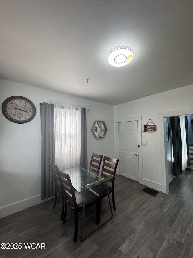 110 Heisel St, Kenton, OH 43326 - dining room featuring baseboards and dark wood-type flooring