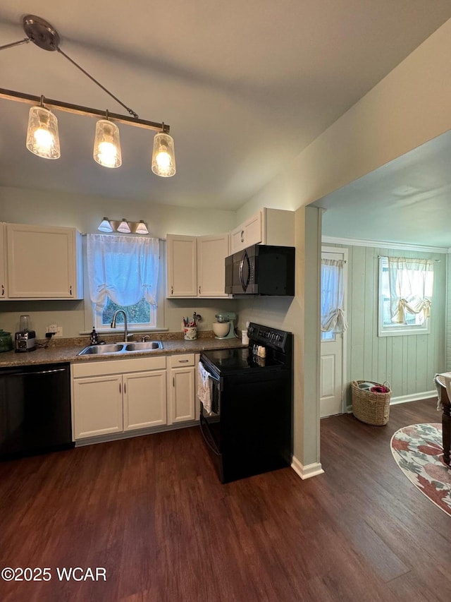 119 E N St, Kenton, OH 43326 - kitchen featuring black appliances, dark wood-type flooring, white cabinets, and pendant lighting