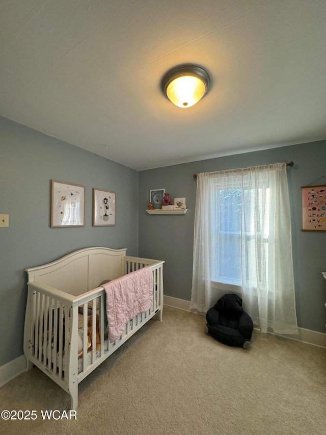 119 E N St, Kenton, OH 43326 - carpeted bedroom with baseboards and a nursery area