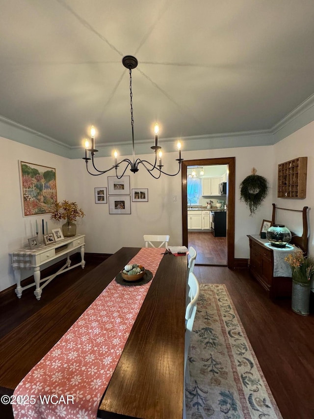 119 E N St, Kenton, OH 43326 - dining area featuring a chandelier, crown molding, and dark wood-type flooring