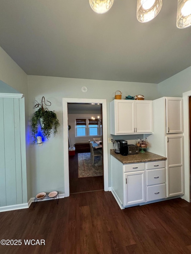 119 E N St, Kenton, OH 43326 - kitchen with dark wood-style flooring, white cabinets, and dark countertops