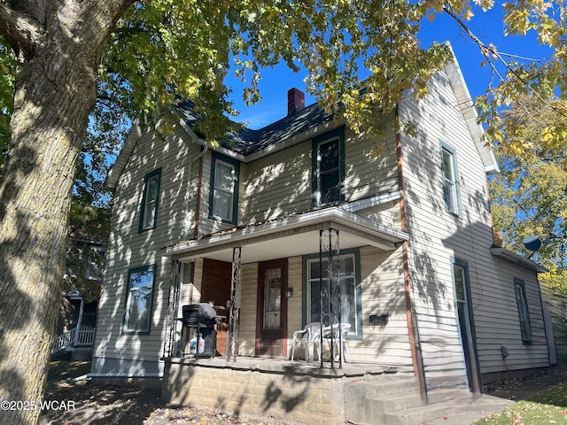 314 N Market St, Kenton, OH 43326 - view of front facade featuring covered porch and a chimney