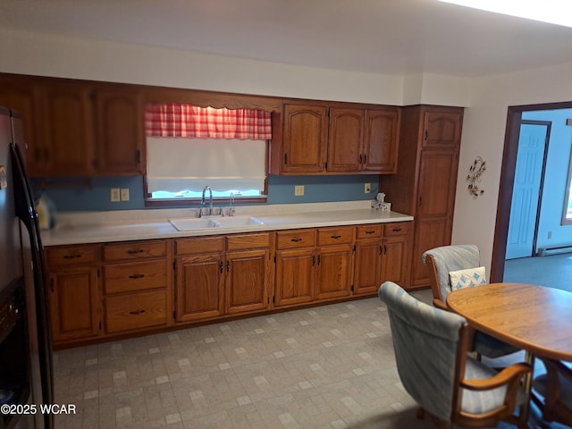 10510 Shenk Rd, Delphos, OH 45833 - kitchen with a sink, stainless steel refrigerator with ice dispenser, brown cabinetry, and light countertops