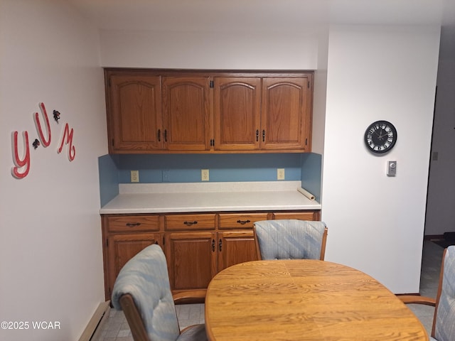 10510 Shenk Rd, Delphos, OH 45833 - kitchen with light countertops, baseboards, and brown cabinets