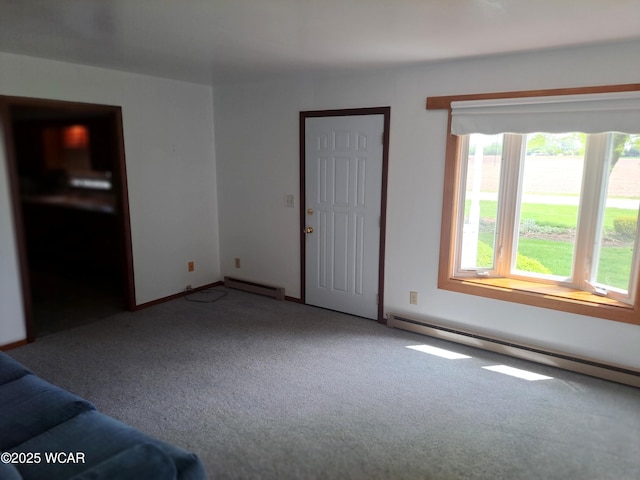 10510 Shenk Rd, Delphos, OH 45833 - unfurnished living room featuring a baseboard heating unit and carpet floors