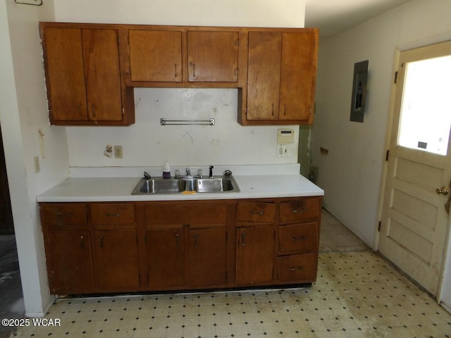 1093 S Sugar St, Lima, OH 45804 - kitchen featuring electric panel, light flooring, light countertops, and brown cabinets