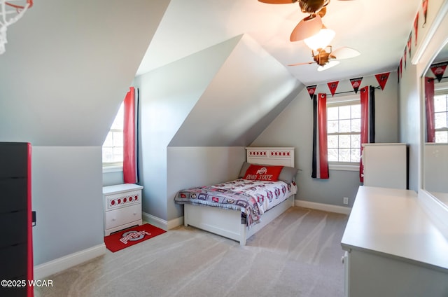 bedroom featuring light carpet, lofted ceiling, and ceiling fan