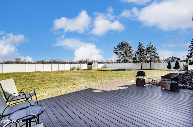 wooden terrace featuring a yard and a storage unit