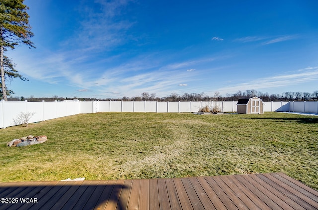 view of yard with a wooden deck and a shed