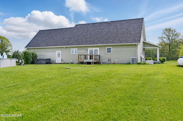 1106 S Grubb Rd, Lima, OH 45806 - rear view of house featuring roof with shingles, a yard, a deck, and a hot tub