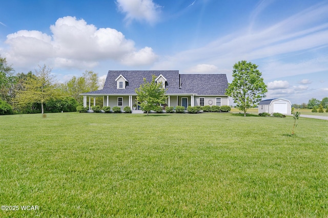 1106 S Grubb Rd, Lima, OH 45806 - view of front of house featuring an outbuilding, a front yard, a shingled roof, and a porch