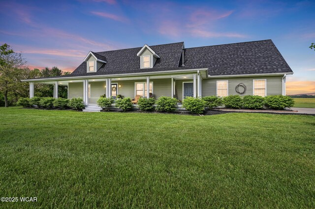 1106 S Grubb Rd, Lima, OH 45806 - farmhouse-style home featuring a lawn, a shingled roof, and covered porch