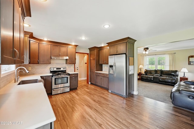 1106 S Grubb Rd, Lima, OH 45806 - kitchen with appliances with stainless steel finishes, a sink, open floor plan, light countertops, and under cabinet range hood