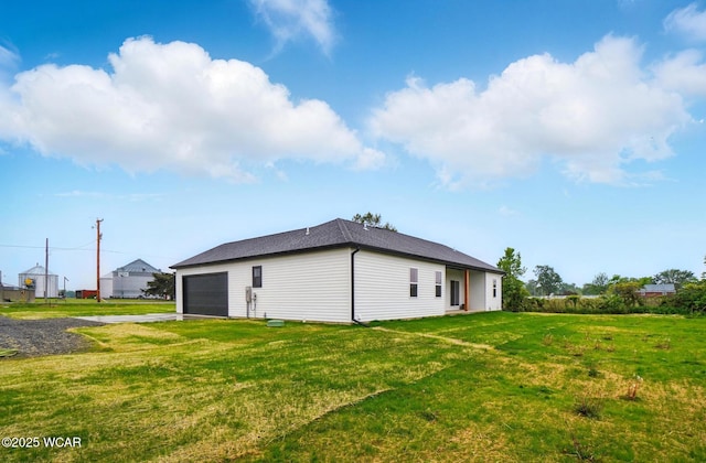 1771 Baty Rd, Lima, OH 45807 - back of property with asphalt driveway, a lawn, and a garage