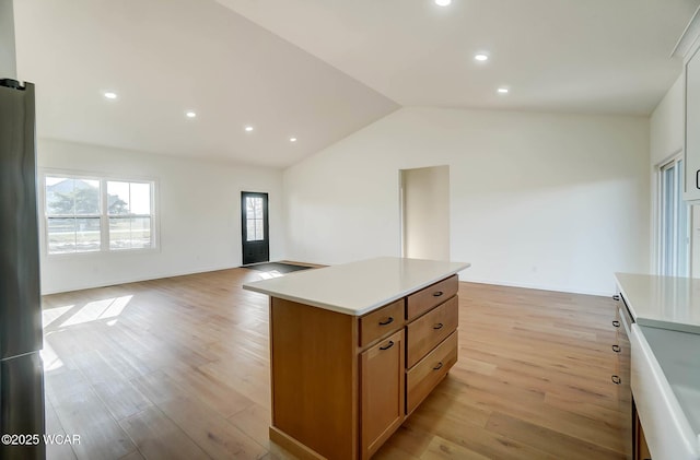 1771 Baty Rd, Lima, OH 45807 - kitchen with lofted ceiling, light wood-style flooring, light countertops, open floor plan, and a center island