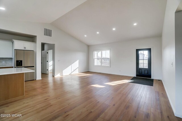 1771 Baty Rd, Lima, OH 45807 - unfurnished living room featuring light wood-style floors, recessed lighting, baseboards, and high vaulted ceiling