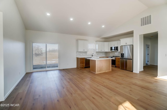 1771 Baty Rd, Lima, OH 45807 - kitchen with stainless steel appliances, light countertops, a center island, open floor plan, and high vaulted ceiling