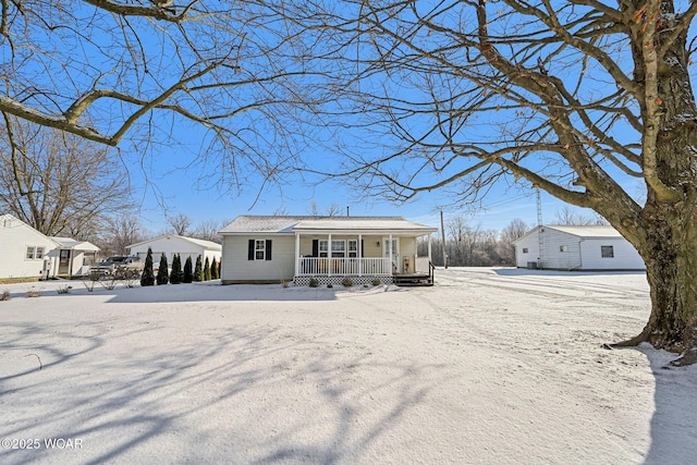 snow covered property with a porch