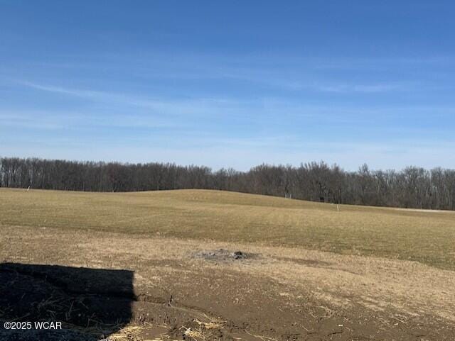 view of landscape with a rural view and a wooded view