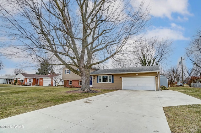 tri-level home with a front lawn, an attached garage, and driveway