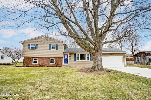 split level home with a garage, brick siding, concrete driveway, and a front yard