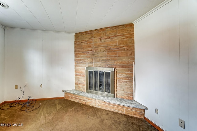 unfurnished living room featuring a stone fireplace, visible vents, baseboards, and carpet