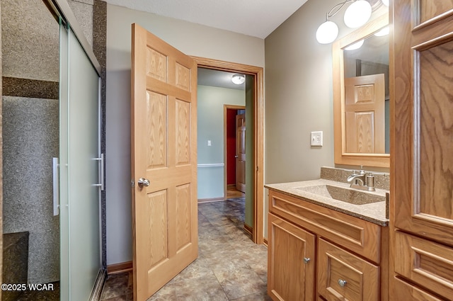 bathroom with vanity and baseboards