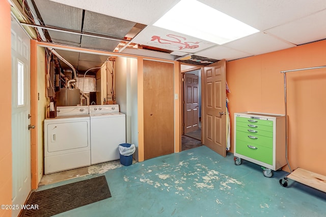 below grade area featuring a drop ceiling and independent washer and dryer