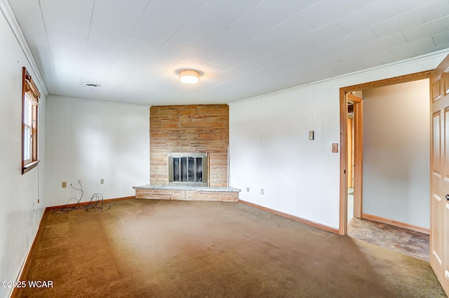 unfurnished living room with baseboards, a stone fireplace, and carpet flooring