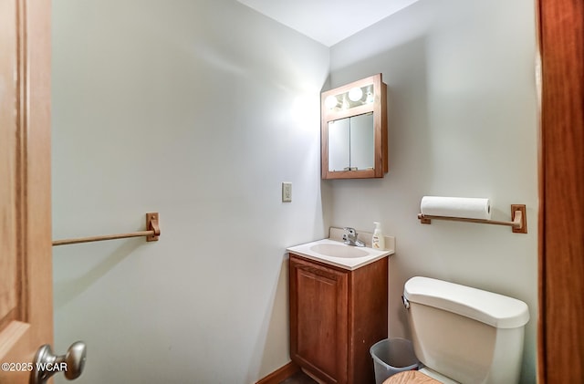 bathroom with toilet and vanity