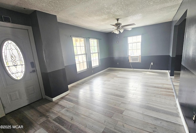 720 S Metcalf St, Lima, OH 45802 - entrance foyer featuring a textured ceiling, a ceiling fan, wood finished floors, baseboards, and cooling unit