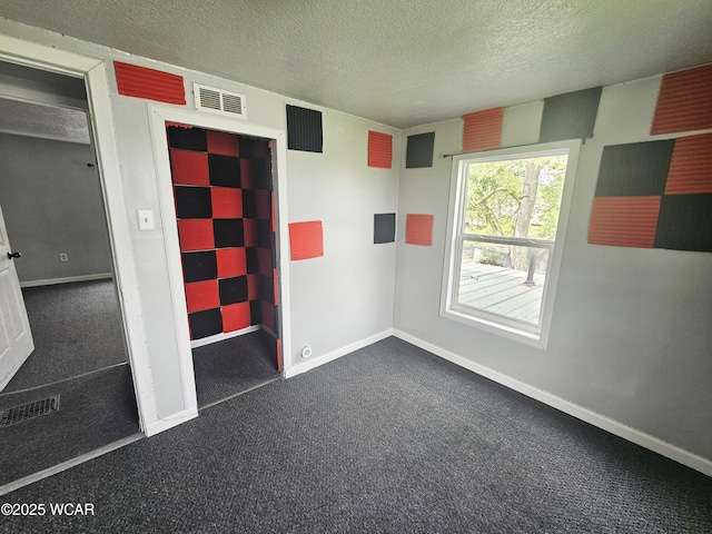 720 S Metcalf St, Lima, OH 45802 - unfurnished room featuring dark colored carpet, a textured ceiling, and baseboards
