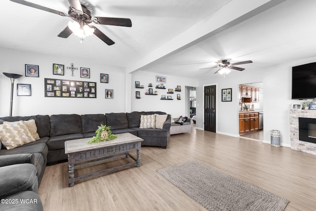 2435 Bible Rd, Lima, OH 45801 - living area featuring a ceiling fan, light wood-style floors, and a stone fireplace
