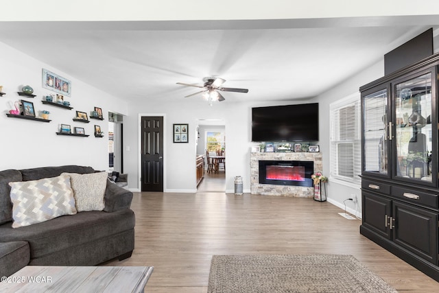 2435 Bible Rd, Lima, OH 45801 - living area featuring a ceiling fan, light wood-type flooring, and a stone fireplace