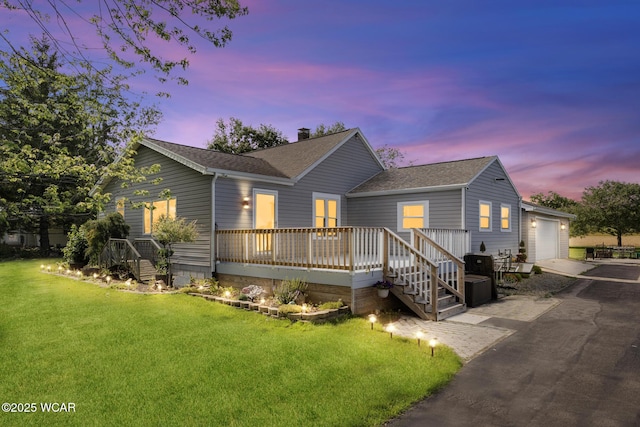 2435 Bible Rd, Lima, OH 45801 - view of front of home with a shingled roof, a yard, a deck, and an attached garage