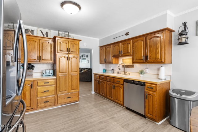 2435 Bible Rd, Lima, OH 45801 - kitchen featuring fridge with ice dispenser, dishwasher, decorative backsplash, light countertops, and ornamental molding