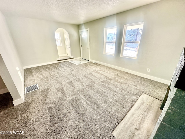 entrance foyer featuring carpet floors and a textured ceiling