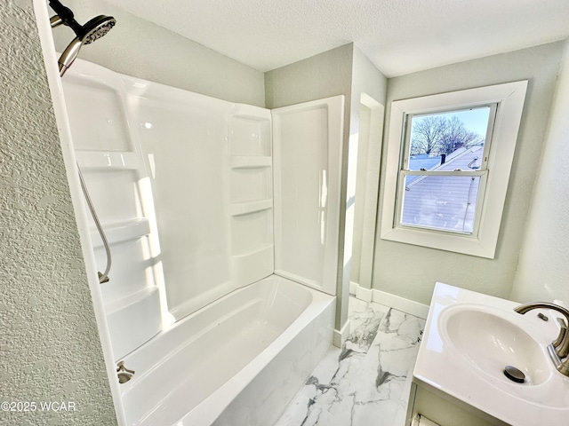 bathroom with vanity, a textured ceiling, and washtub / shower combination