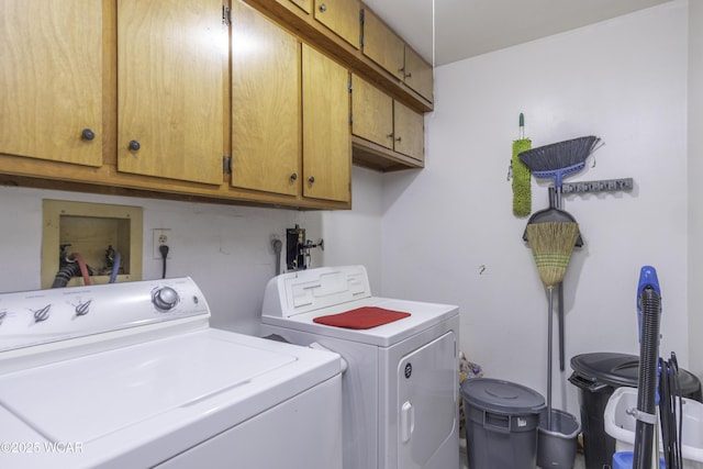 laundry room with independent washer and dryer and cabinet space