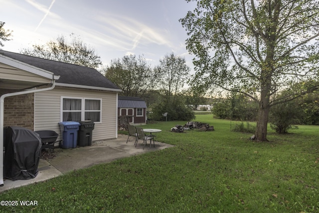 view of yard with an outdoor structure and a patio