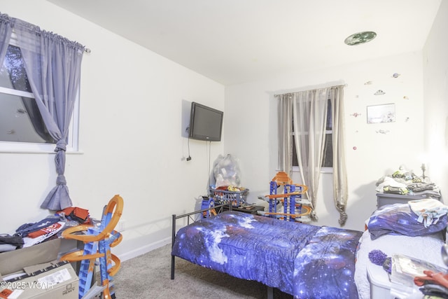 bedroom featuring carpet and baseboards