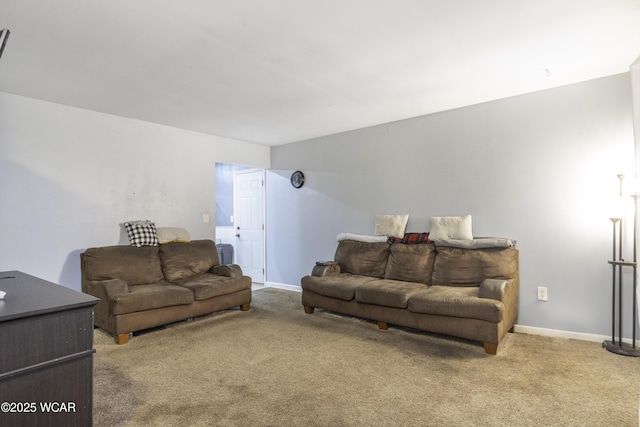 carpeted living area featuring baseboards