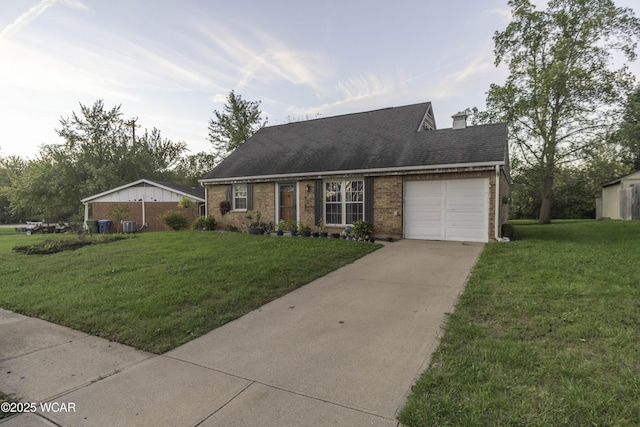 view of front of property featuring a garage, brick siding, driveway, and a front lawn