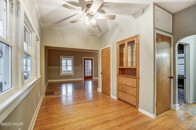 spare room with ceiling fan and light wood-type flooring