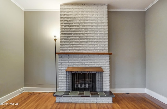 unfurnished living room featuring hardwood / wood-style flooring, a fireplace, and ornamental molding