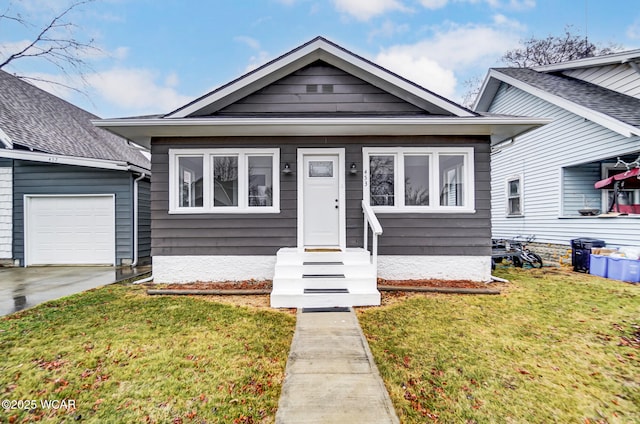 bungalow featuring a garage and a front yard