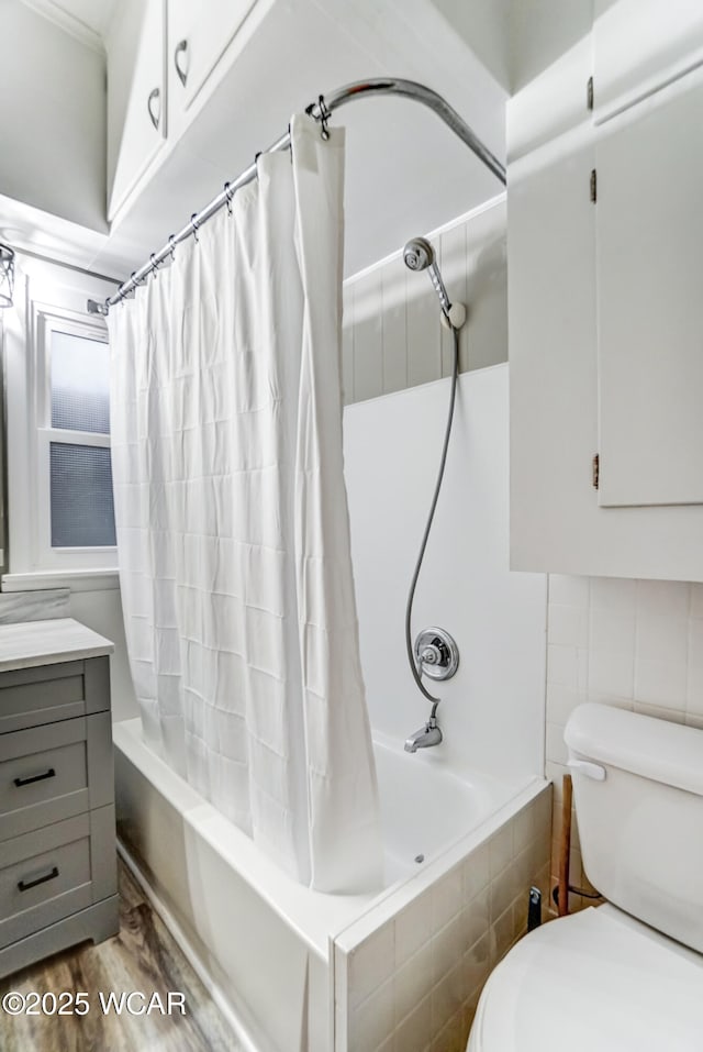 full bathroom featuring hardwood / wood-style flooring, vanity, toilet, and shower / tub combo