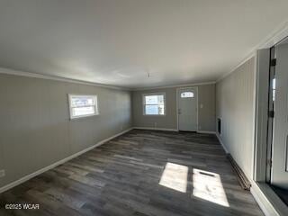 foyer with baseboards, crown molding, and wood finished floors