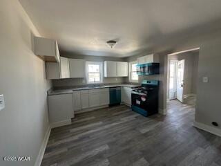 kitchen with baseboards, white cabinets, dishwashing machine, gas range, and stainless steel microwave